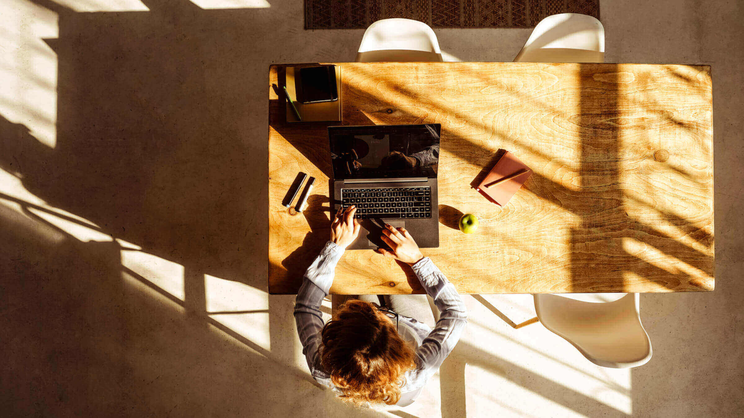 Aerial photo of a woman sitting at her desk